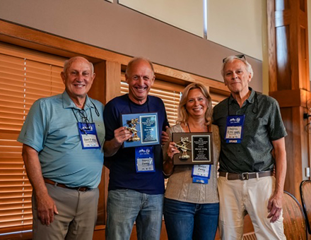 Bristol Mountain s Dan Fuller left and Holiday Valley s Dennis Eshbaugh right presented attorneys Steve and Maryjo Zweig with the Stafford Safety in Skiing AwardJPG