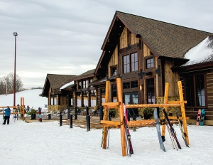 The new lodge, pictured here, was dropped in elevation by 12 feet to provide level access,  and the dirt was repurposed to other areas of the ski area.