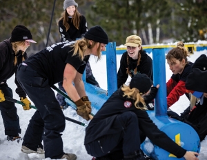 The all-female build crew, including author Marsha Hovey (third from right), at Take the Rake—a women's terrain park meet-up at Trollhaugen, Wis., in 2021.