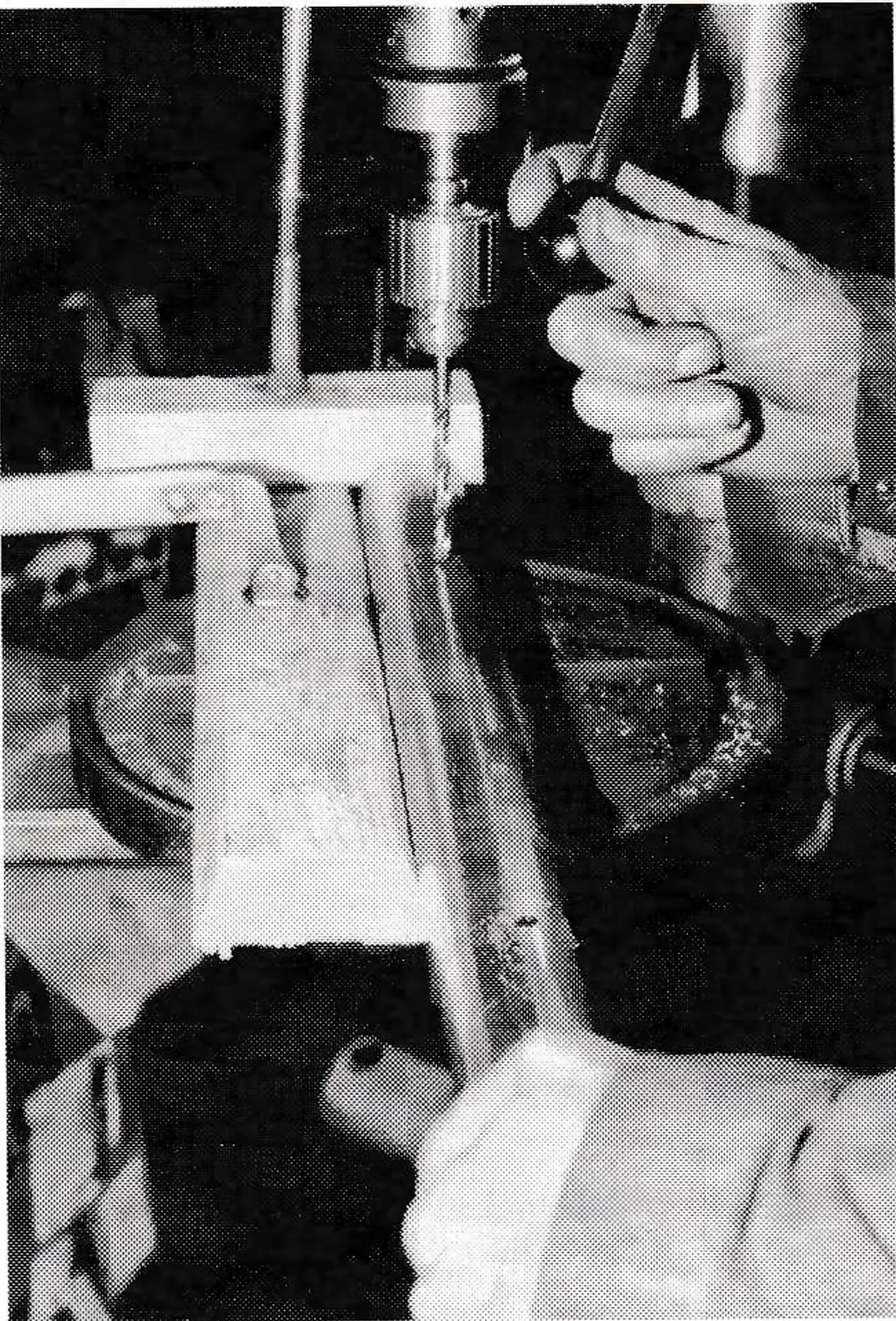 Conduit is drilled using wood blocks clamped to the drill-press table to make locating the center easier.