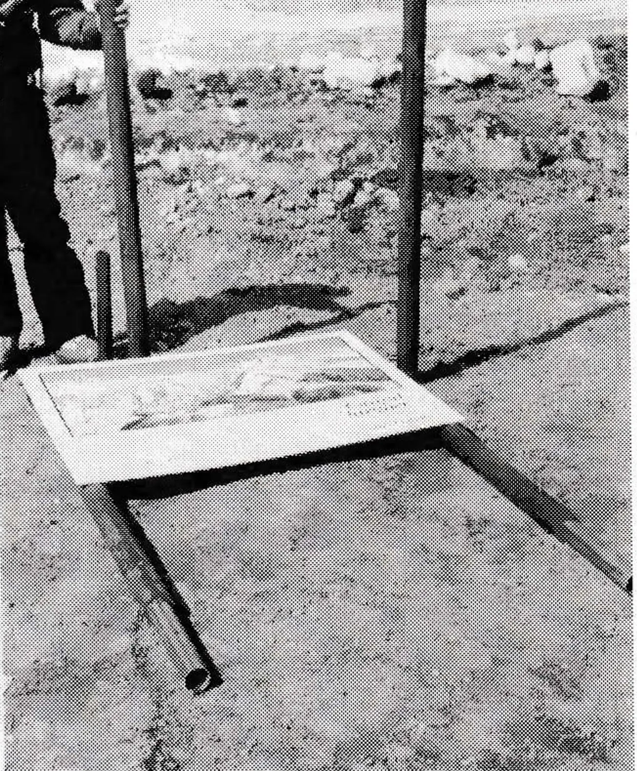 Plastic pipe is drilled then slipped over the steel pipe before the sign is put in place on the pipes.