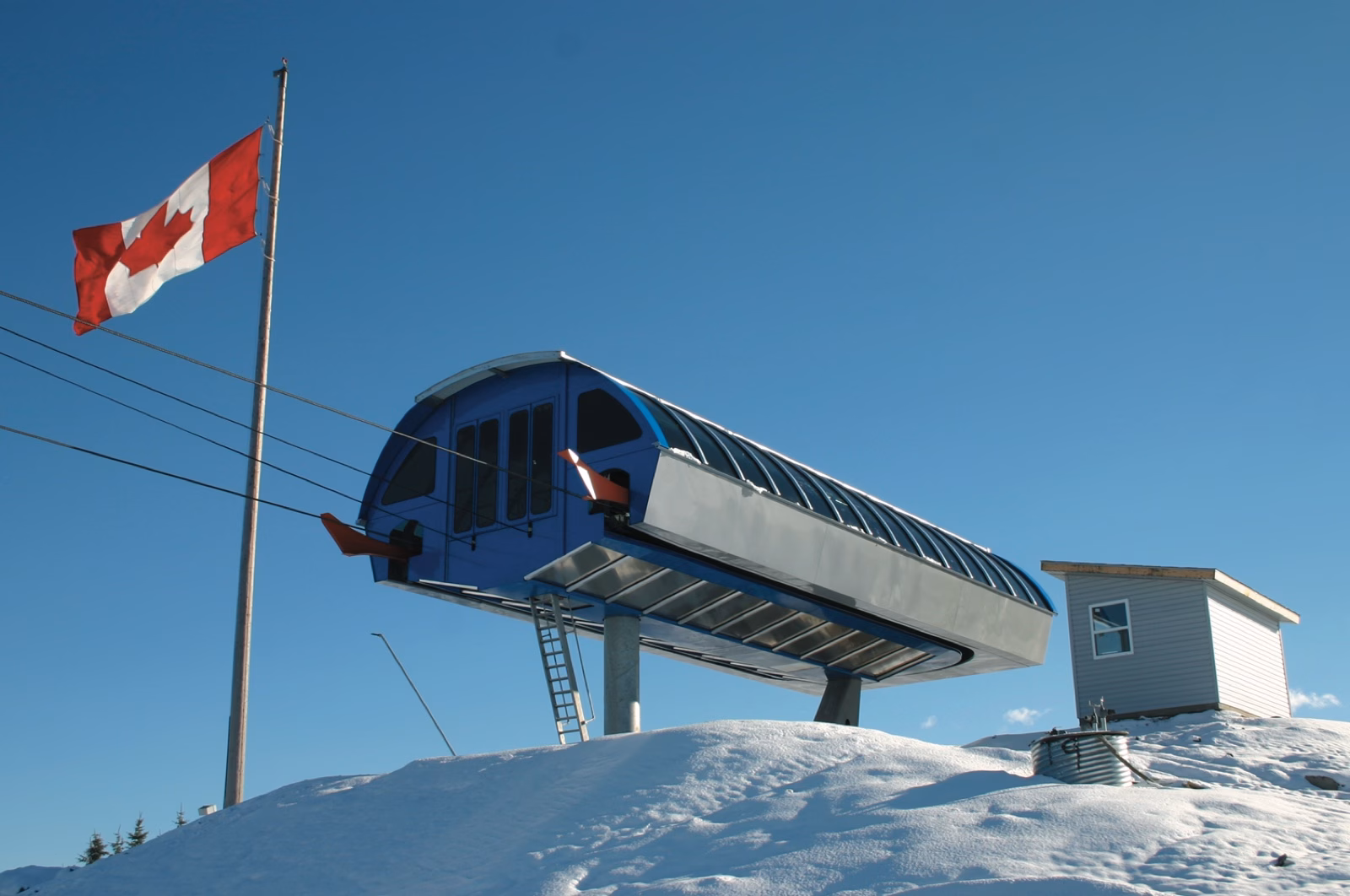 Detachable quad terminal at Canada Olympic Park under a Canadian flag