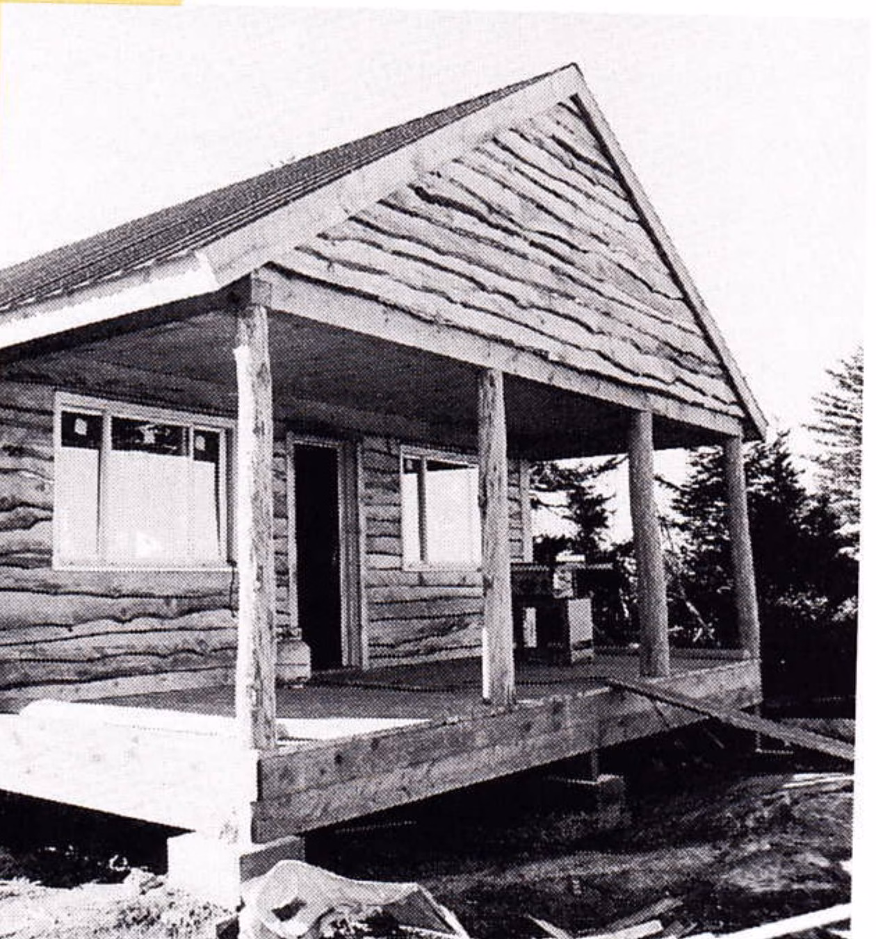 New rough-hewn log safety services building with a full-length timber porch at the summit of Gunstock