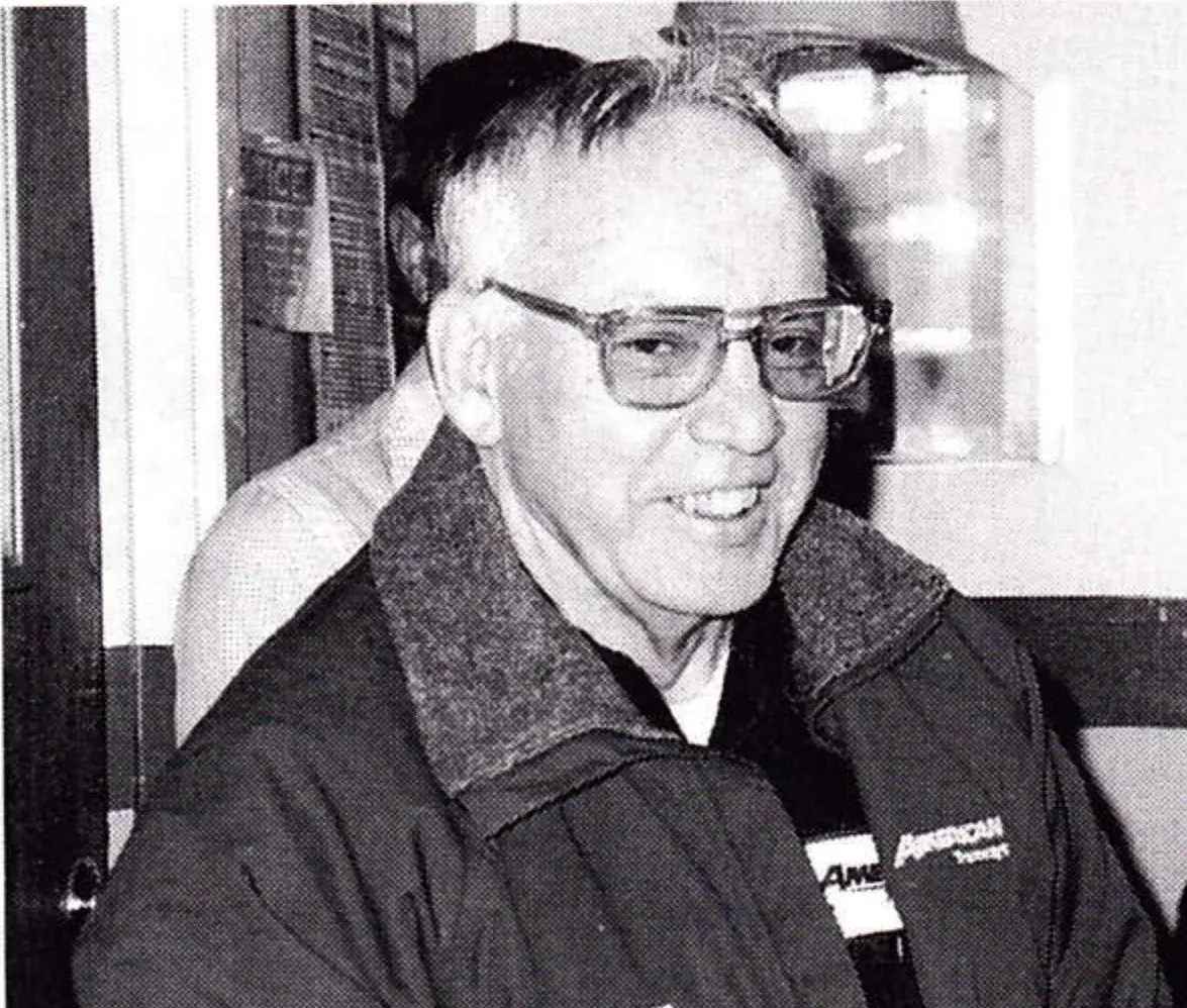 Portrait of Robert Davis, smiling, wearing glasses and an American Tramways jacket