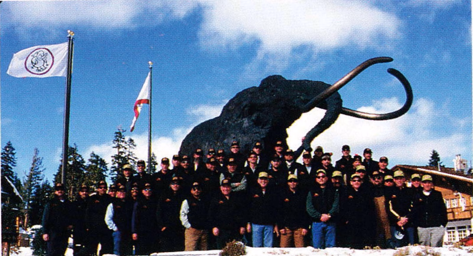 Group photo of symposium participants in front of a large woolly mammoth statue at Mammoth Mountain