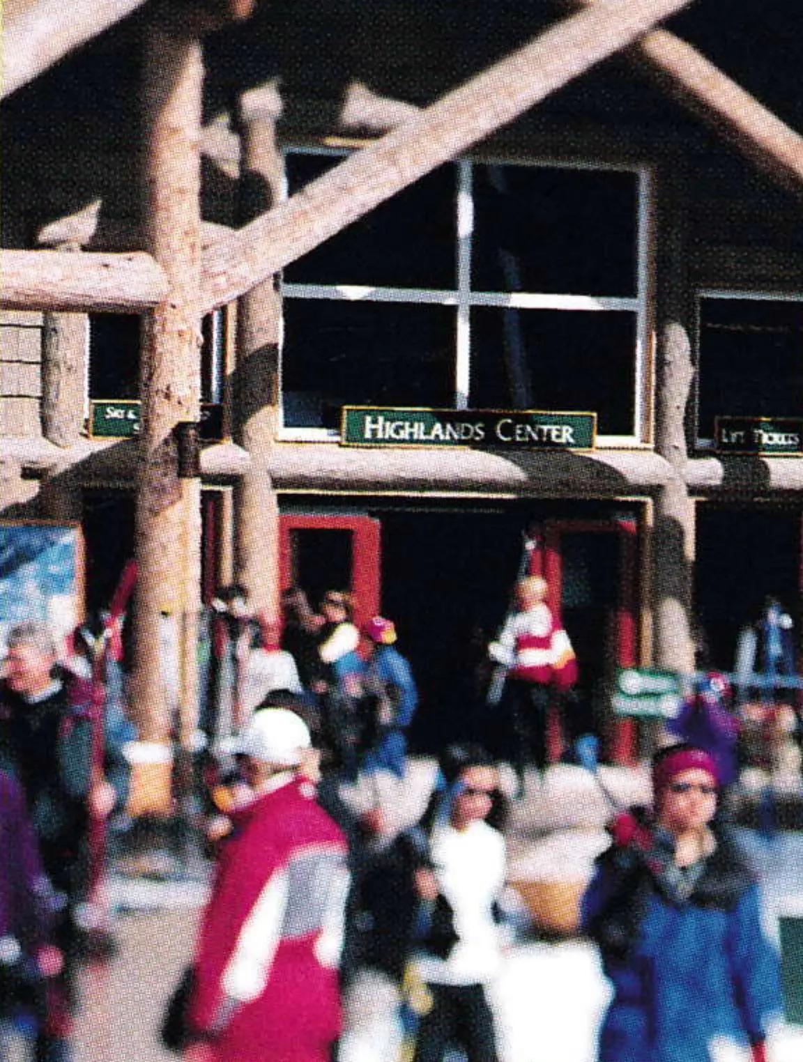 Skiers gathered outside the Highlands Center timber building at the base area