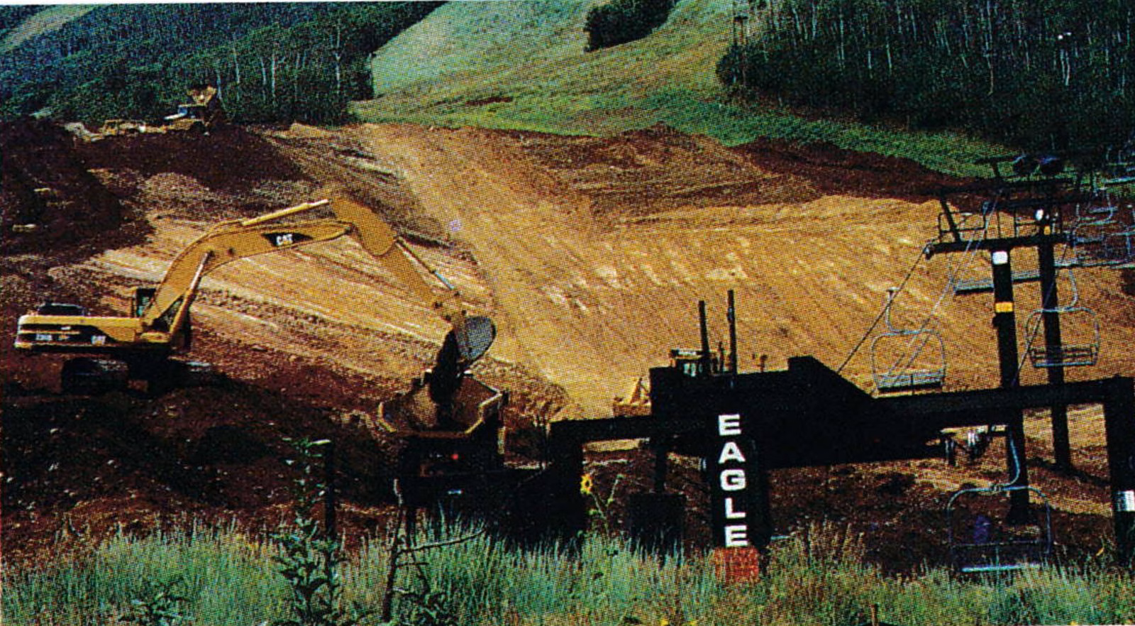 Excavators regrading a broad dirt area at the base of the Eagle lift