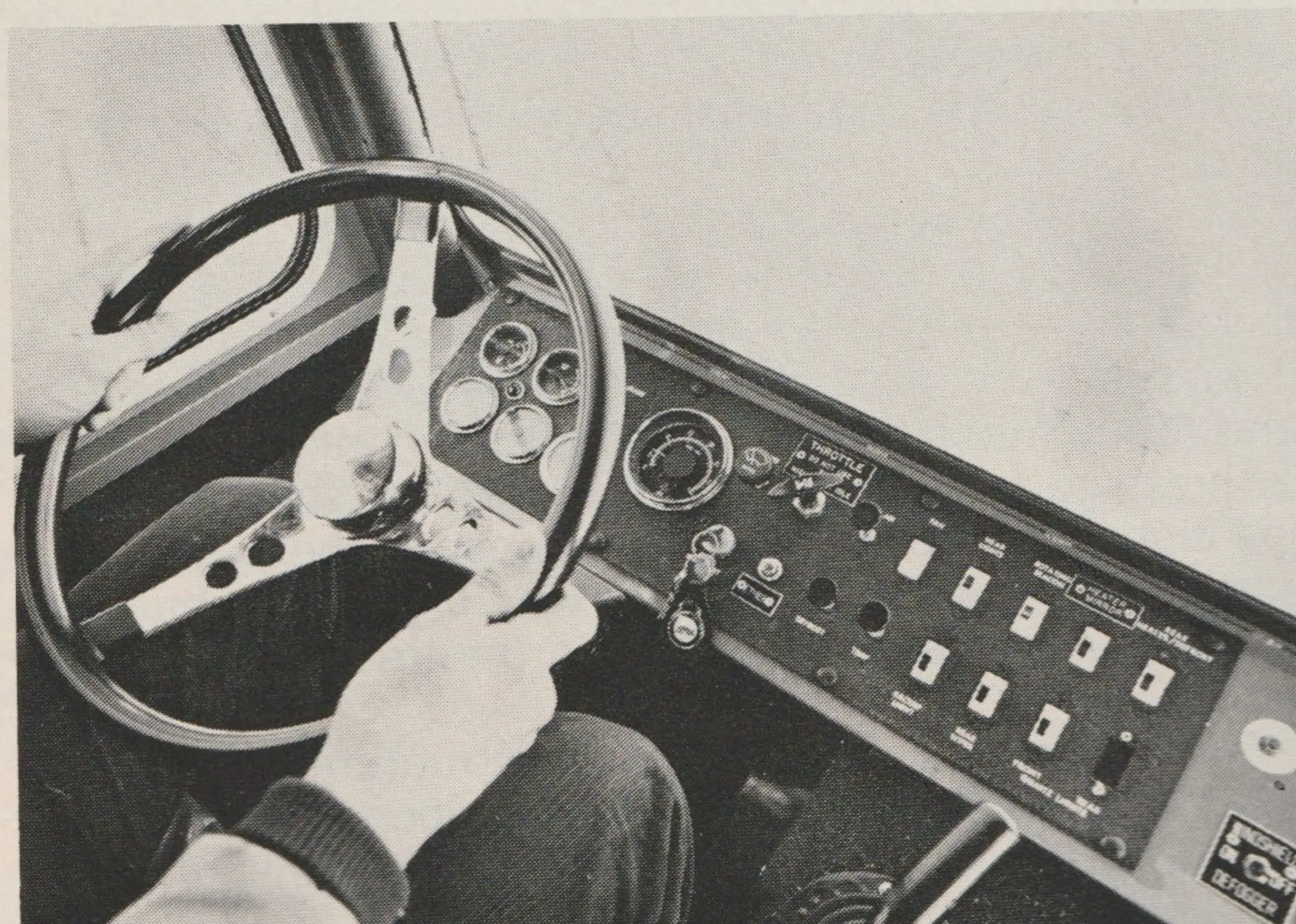 Tucker 1600 Mid-Engine with conventionally-located instrument cluster, sport steering wheel and well-positioned T handle which controls hydraulics for front-mounted attachments.
