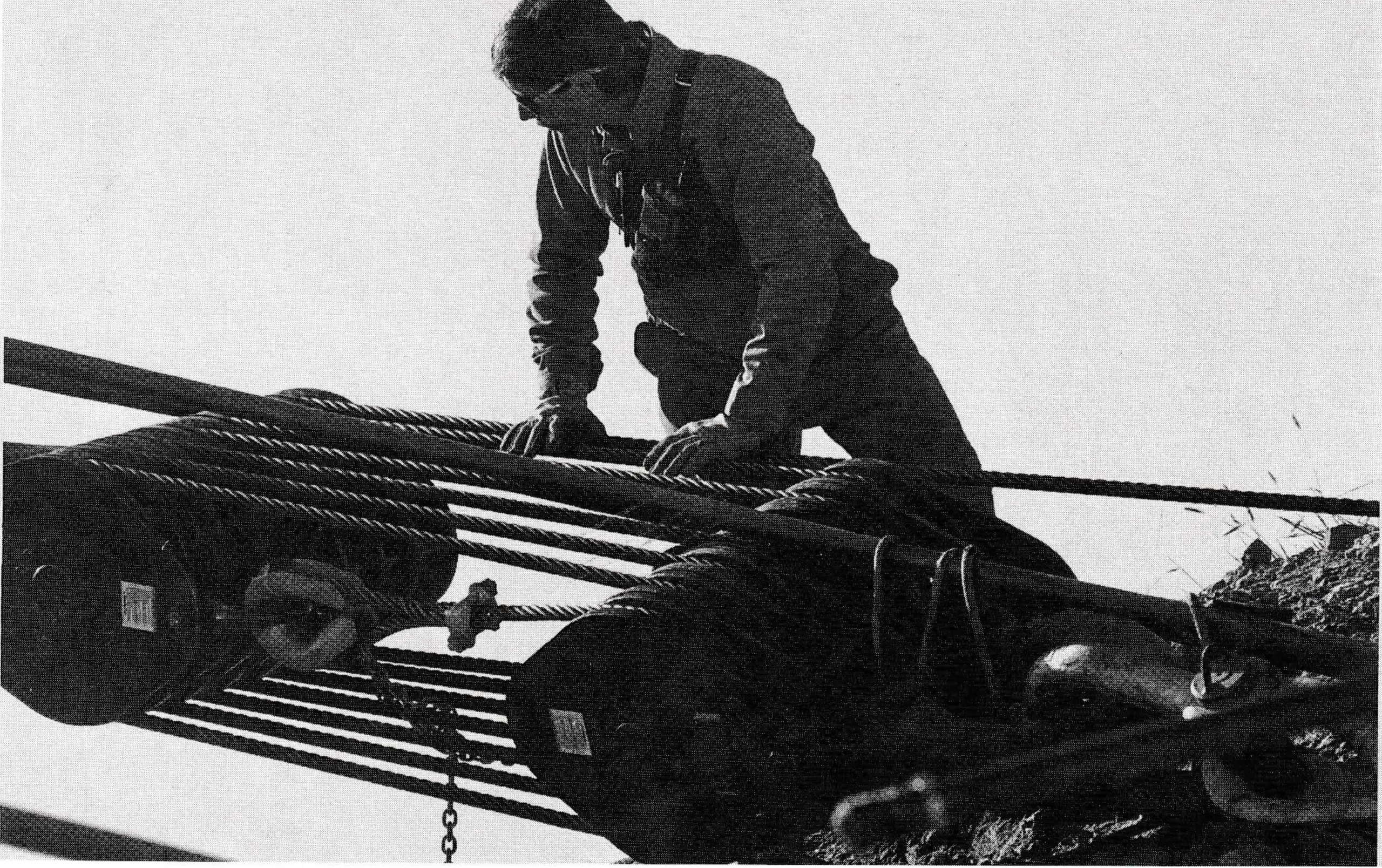 Mark Roundtree checks the two-ton block and tackle assembly for the umpteenth time before the big move to the cable. Photo by Angus Thuermer.