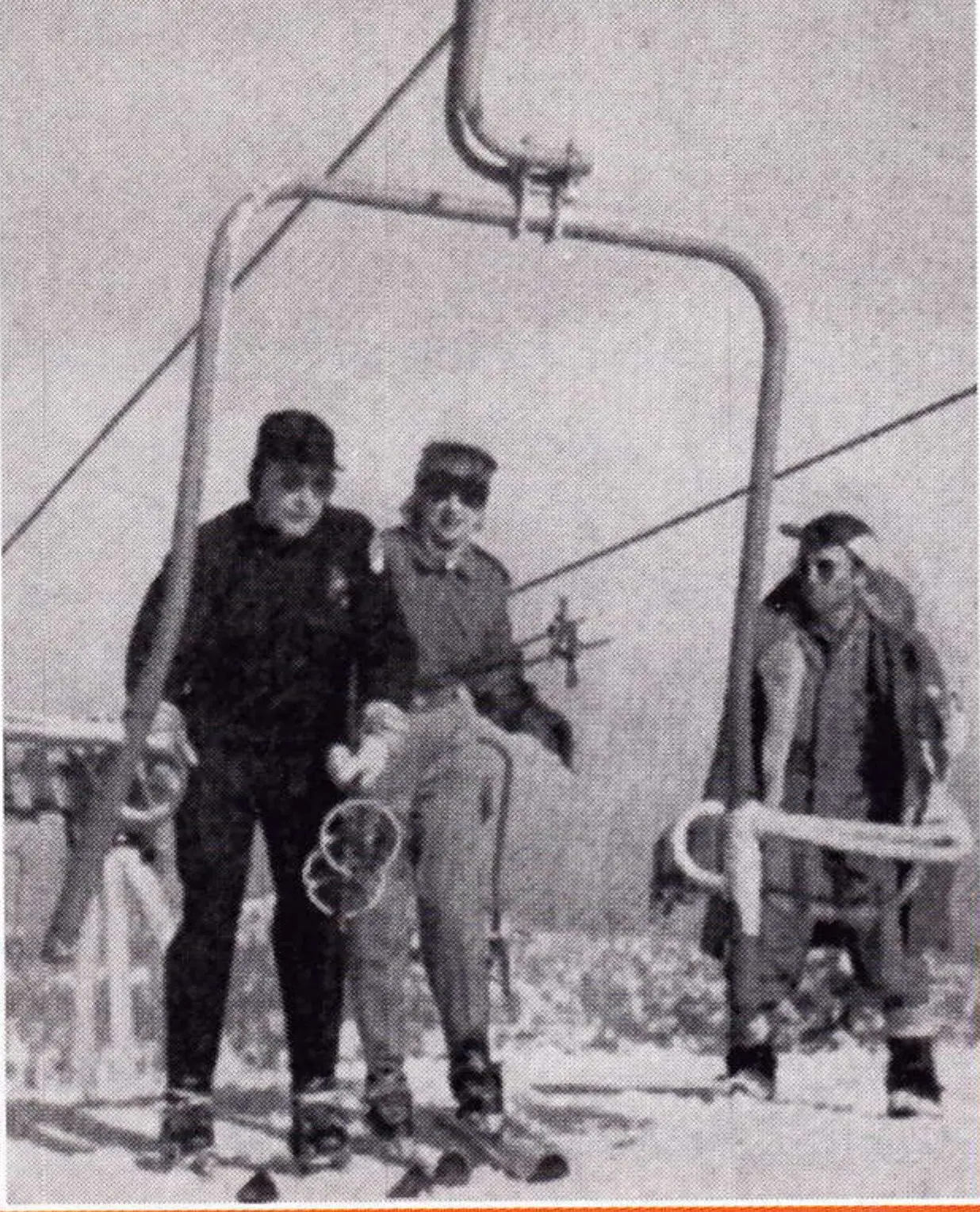 1952 magazine photo of skiers standing as a Ringer double-swivel chair unloads at Holiday Hill