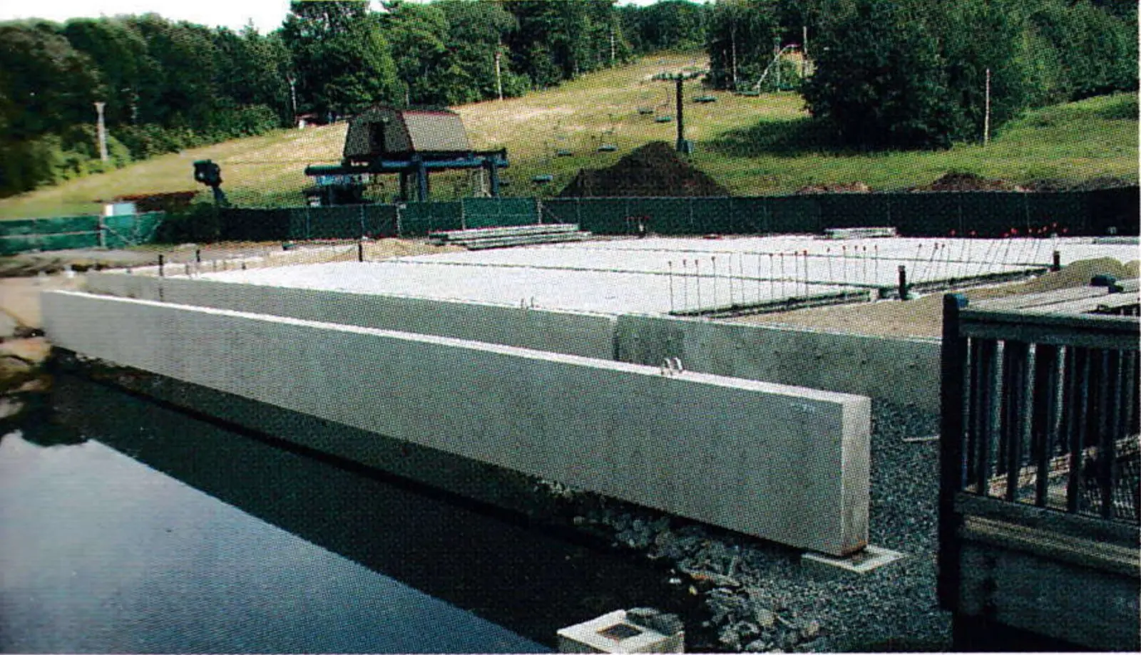 Wachusett Mountain: pre-cast concrete beams spanning the drained snowmaking pond for the lodge addition