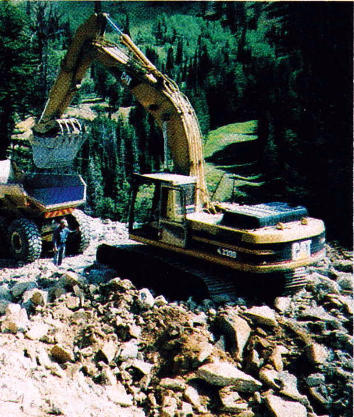 Grand Targhee: an excavator and dump truck regrading the access road