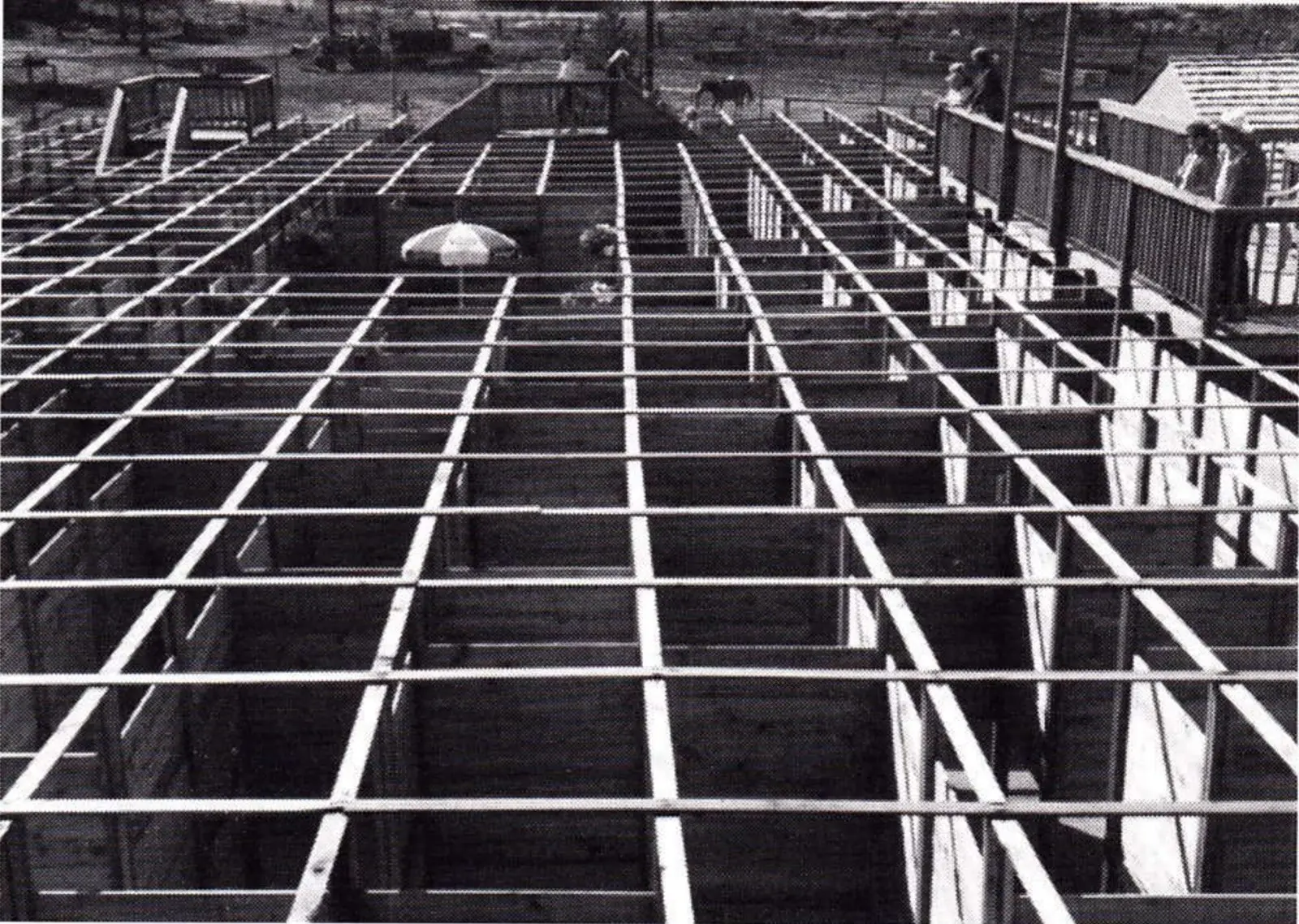 Overhead view of a wood-framed walk-through maze grid in a resort parking area