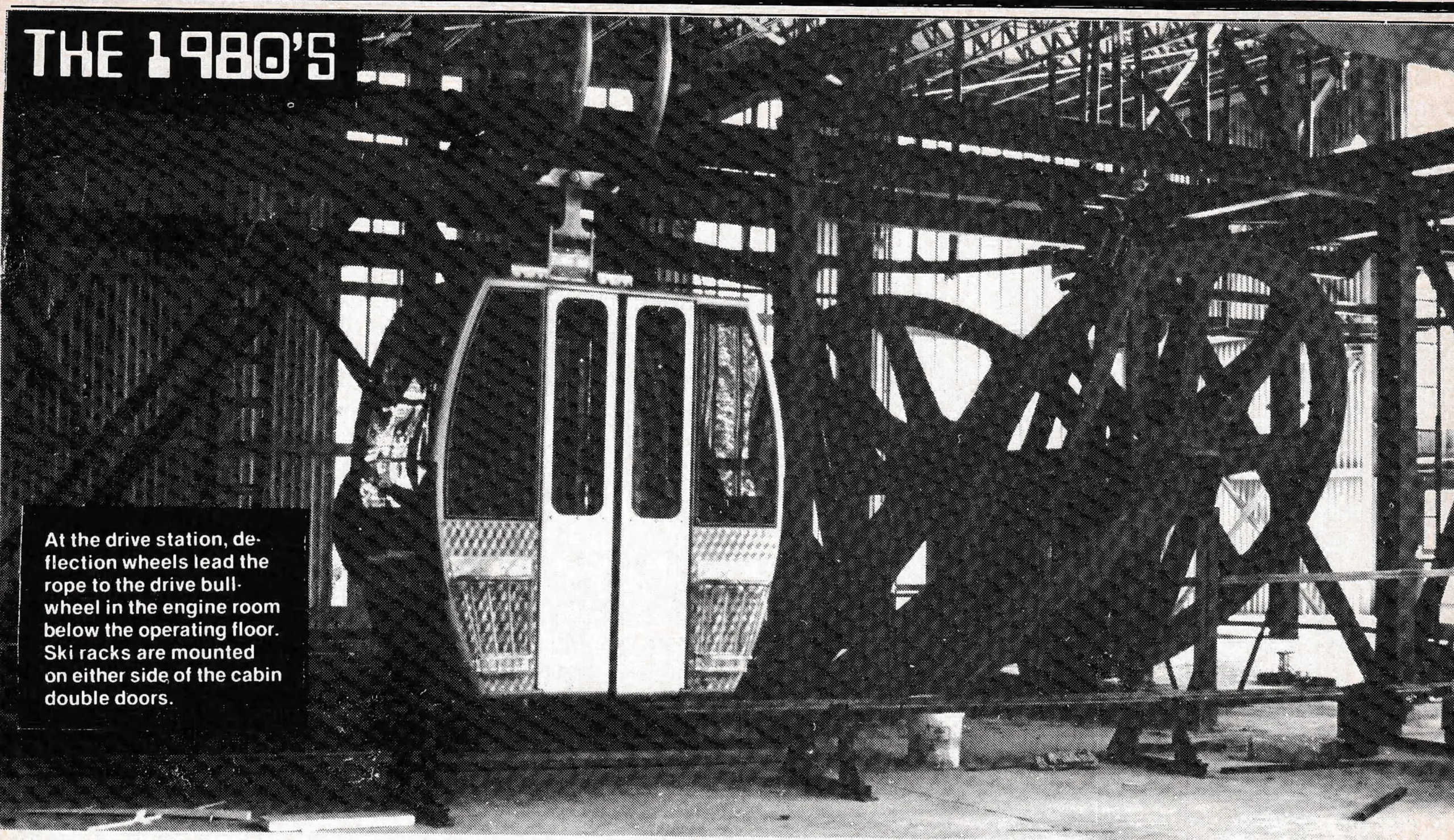 At the drive station, deflection wheels lead the rope to the drive bullwheel in the engine room below the operating floor. Ski racks are mounted on either side of the cabin double doors.