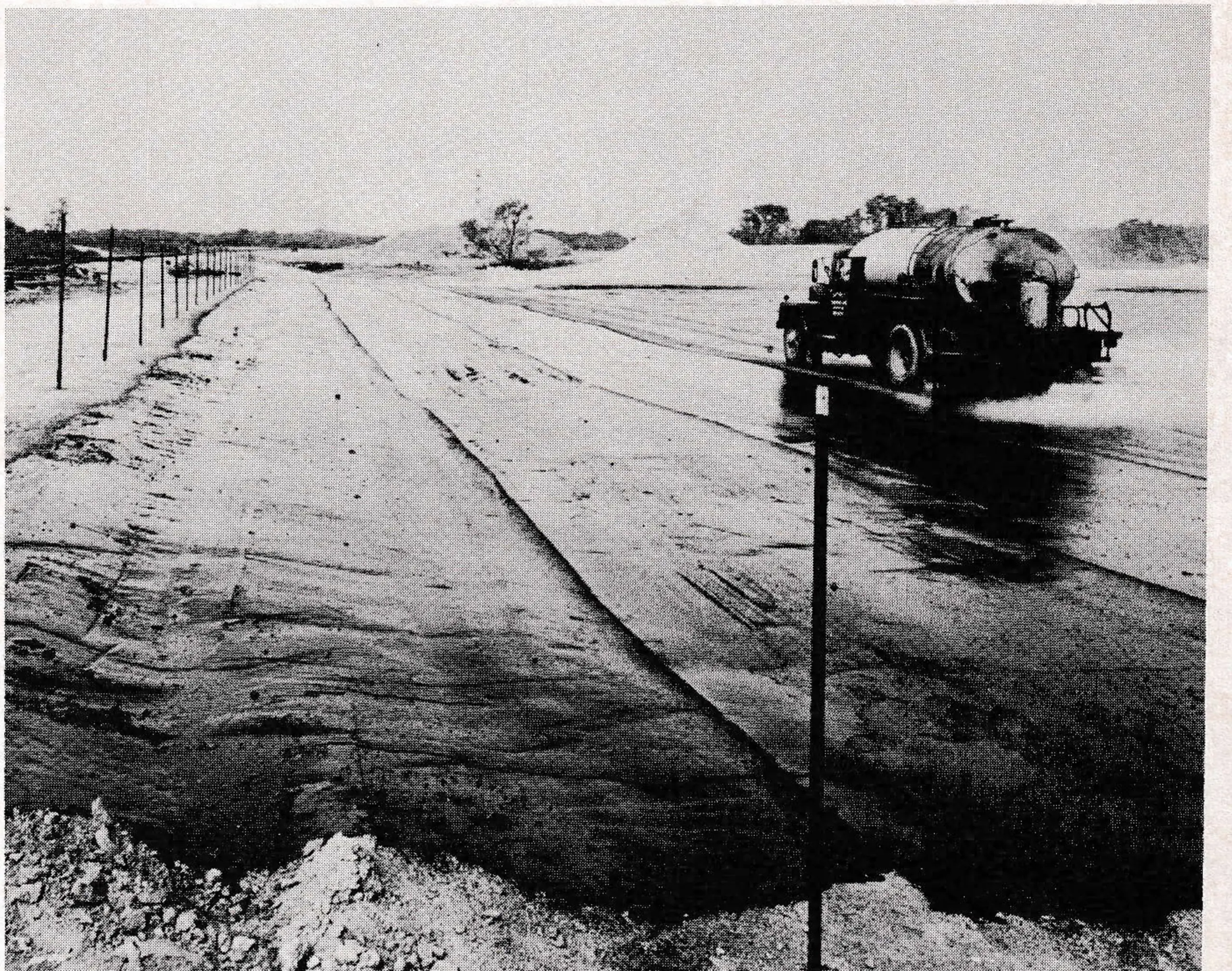 Asphalt membrane, which will collect leachate water and channel it to a treatment point, gets a coating of macadam before landfill is brought in.