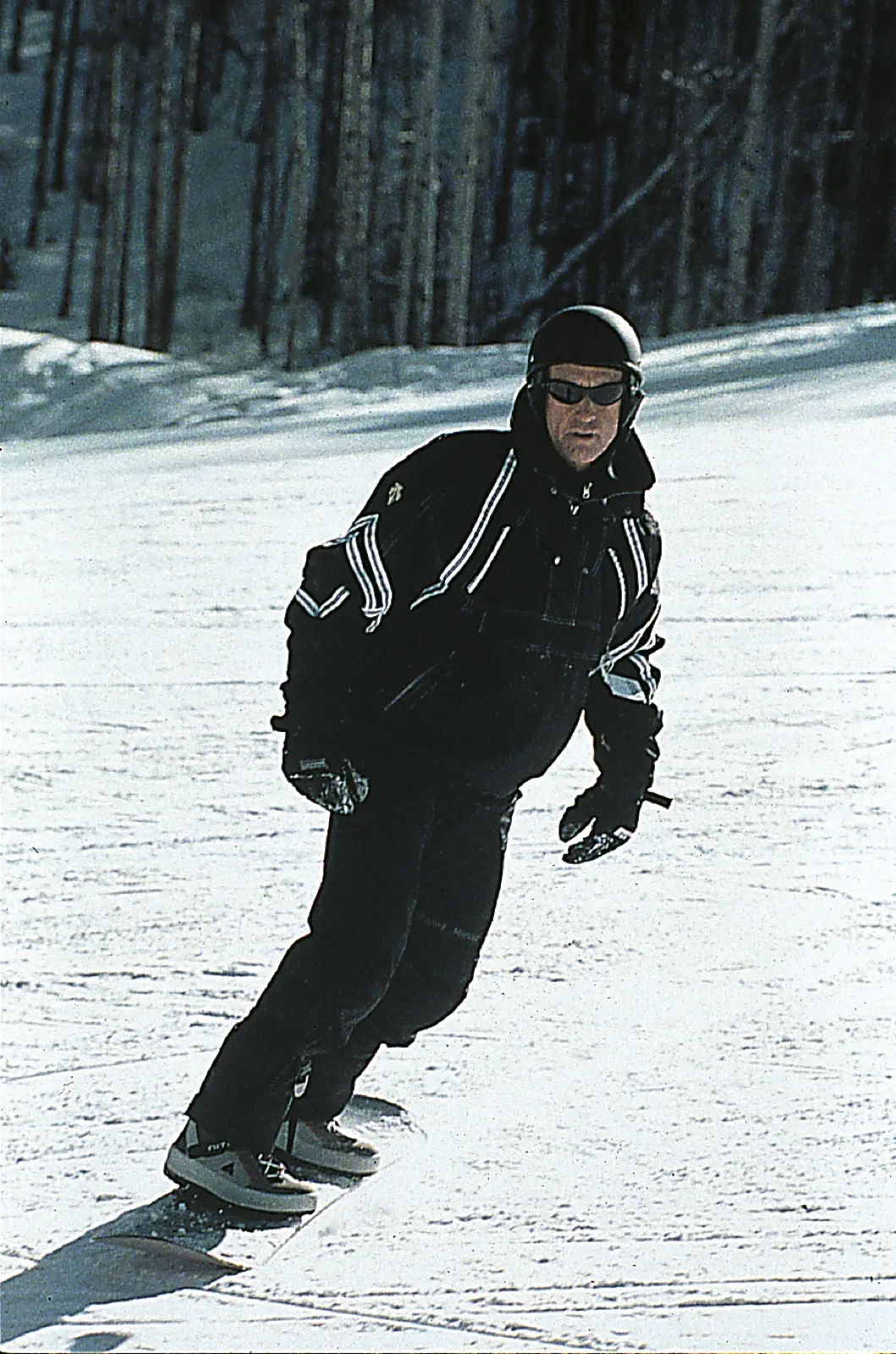 Pat O’Donnell snowboarding down a groomed run