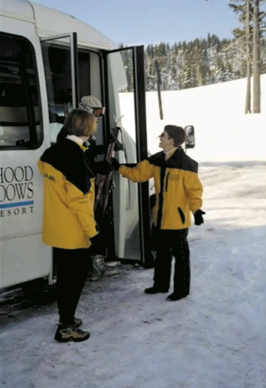 Mt. Hood Meadows staff greeting a first-timer at a shuttle bus door