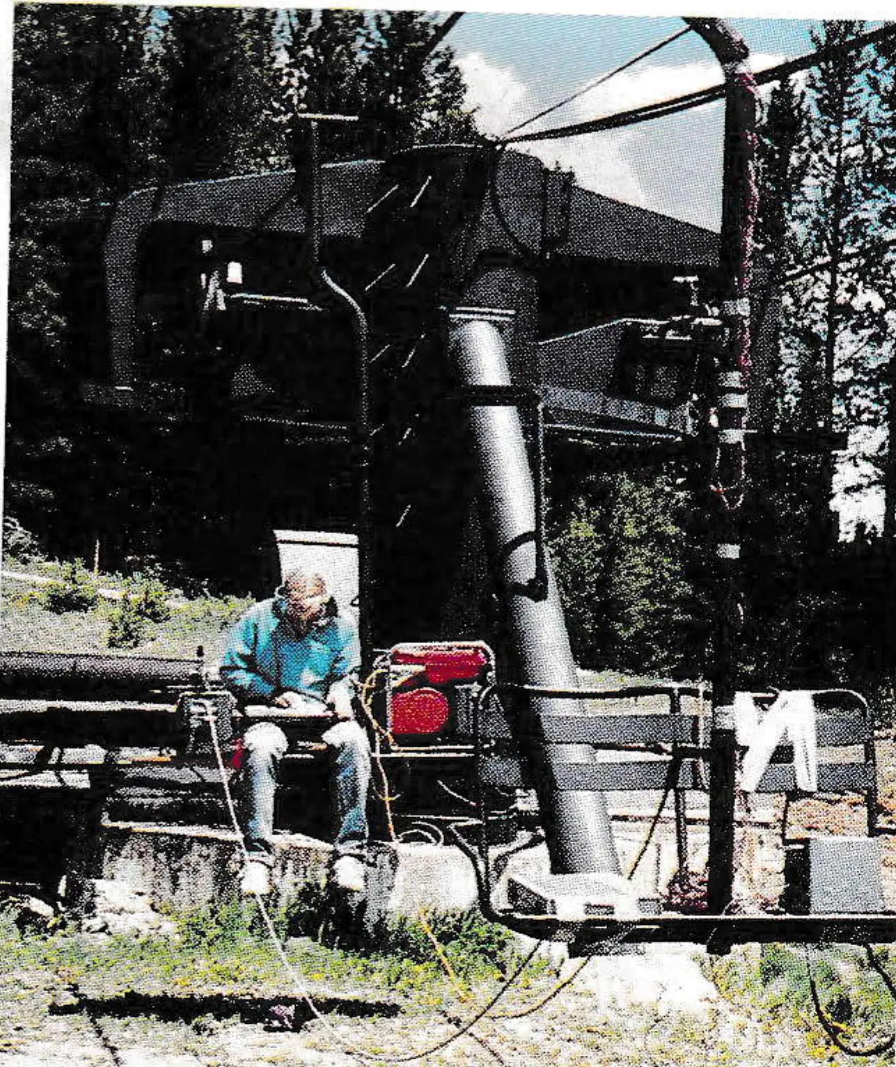 Tad Nordstrom of Jenlynn sits in chair 15 feet behind test chair with computer measuring equipment.