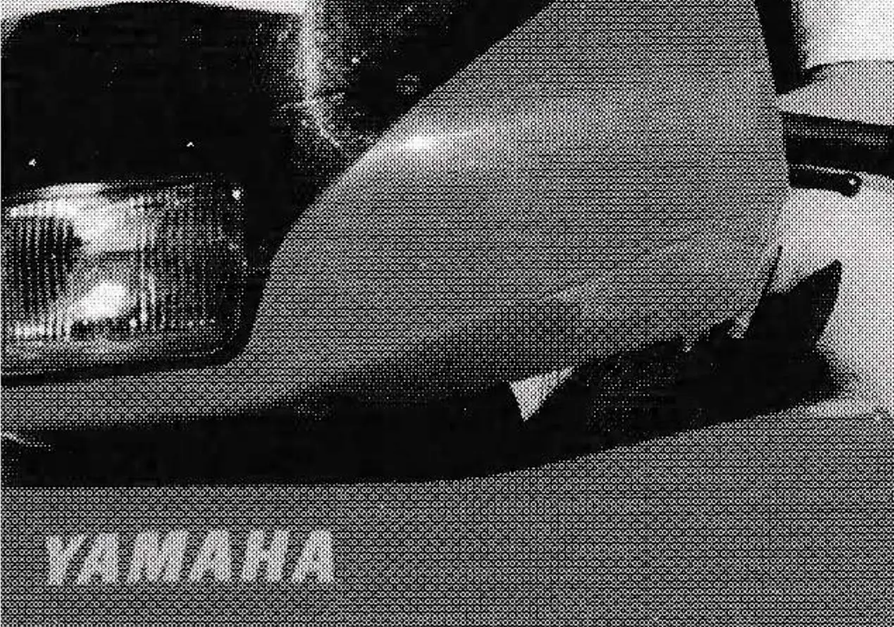 Murray Miller in sunglasses sitting on a Yamaha snowmobile