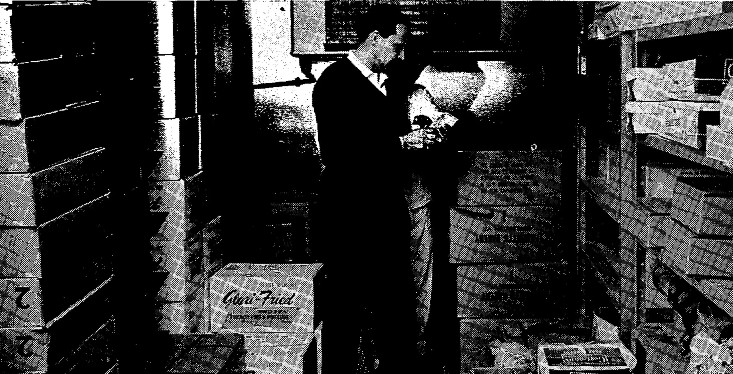 Concessionaire Pappas checks his inventory in walk-in freezer. Large space devoted to this is insurance against unexpected crowds, unexpected washouts and interrupted deliveries.