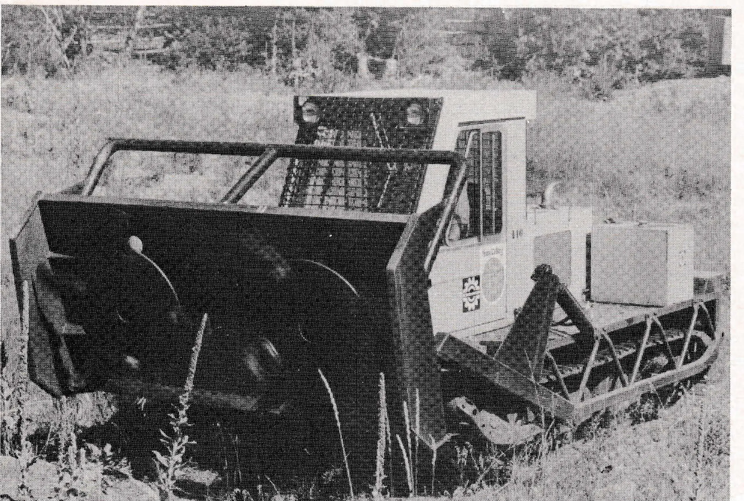 Raised mower shows twin hydraulically-driven blades of the Muskeg Brush Cutter.