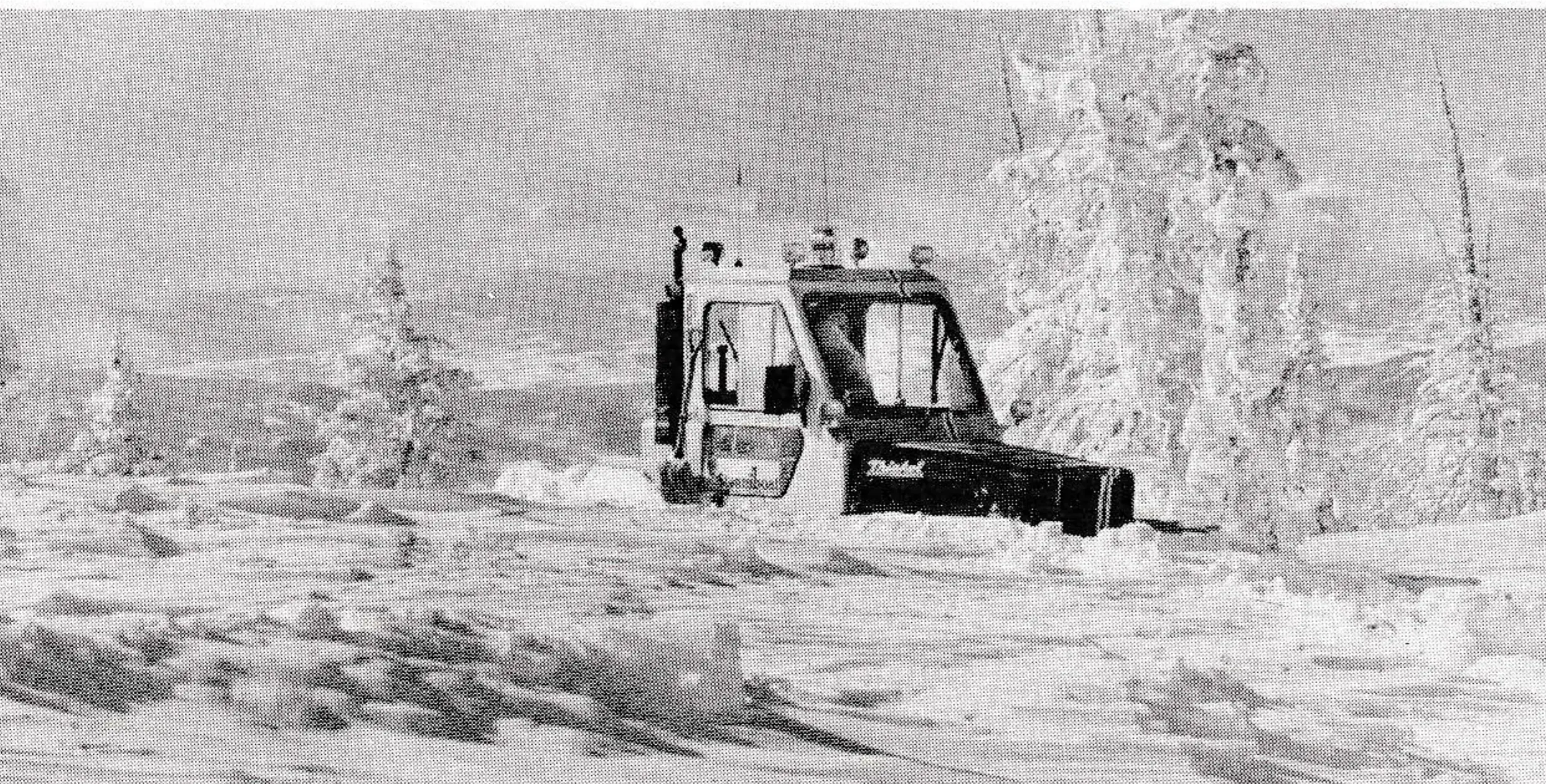 A Thiokol busts through tough five-foot snow bank on top of the mountain.