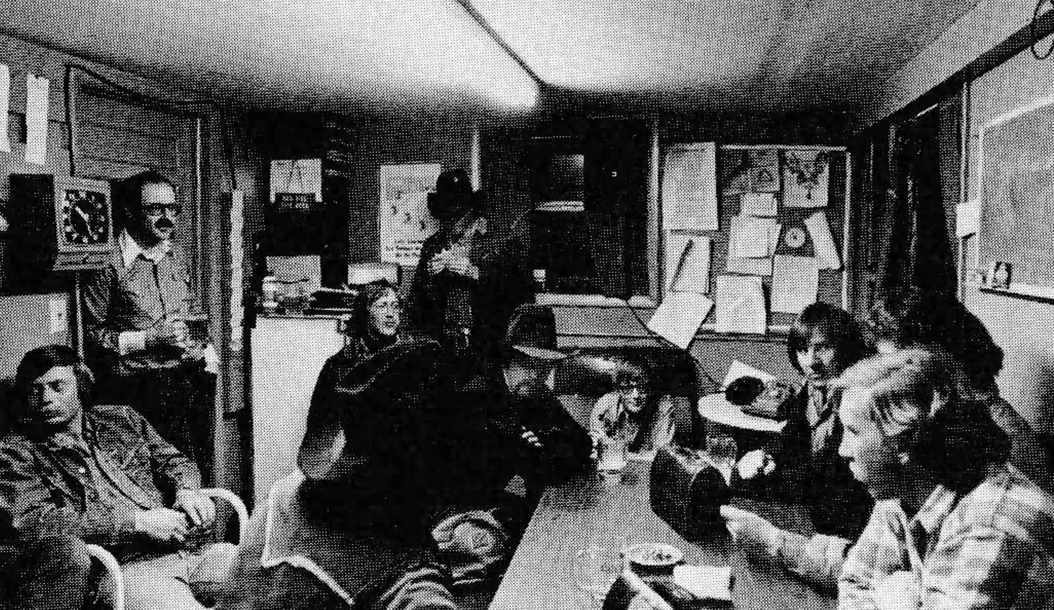 The crew gets together for break. Gary Kline, Steamboat's mountain manager, is leaning against the clock.