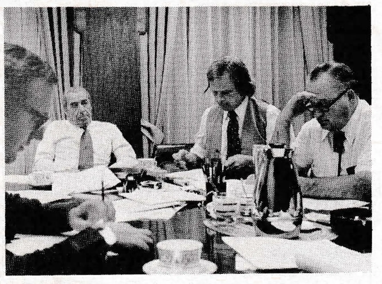“Saturday night with the boys!” Fatigue shows on the faces of (left, foreground) Chuck Lewis, Bill Norton, Garry Mitchell and George Hartzog as they plan strategy