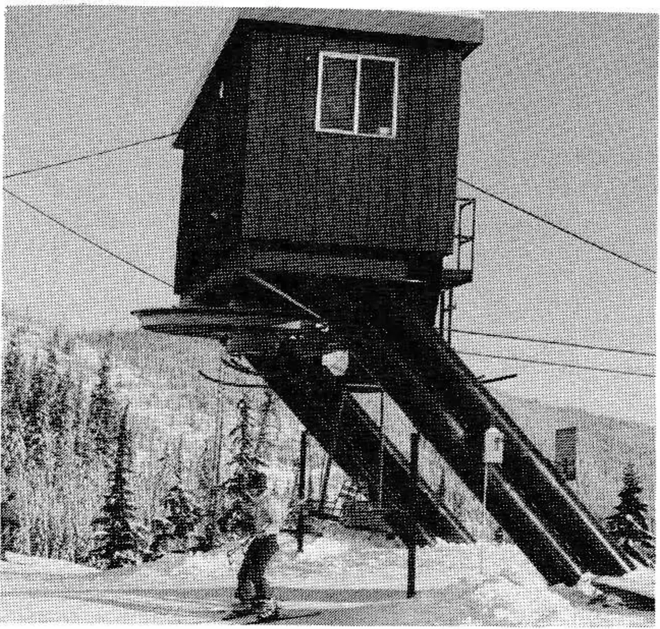 The upper terminal (center) is of the overhead gantry type, bullwheel unloading system with the cantilever support structure sloping at 45 degrees to provide for complete freedom to turn immediately after the skier leaves the chair. Picture #4 shows a side view.