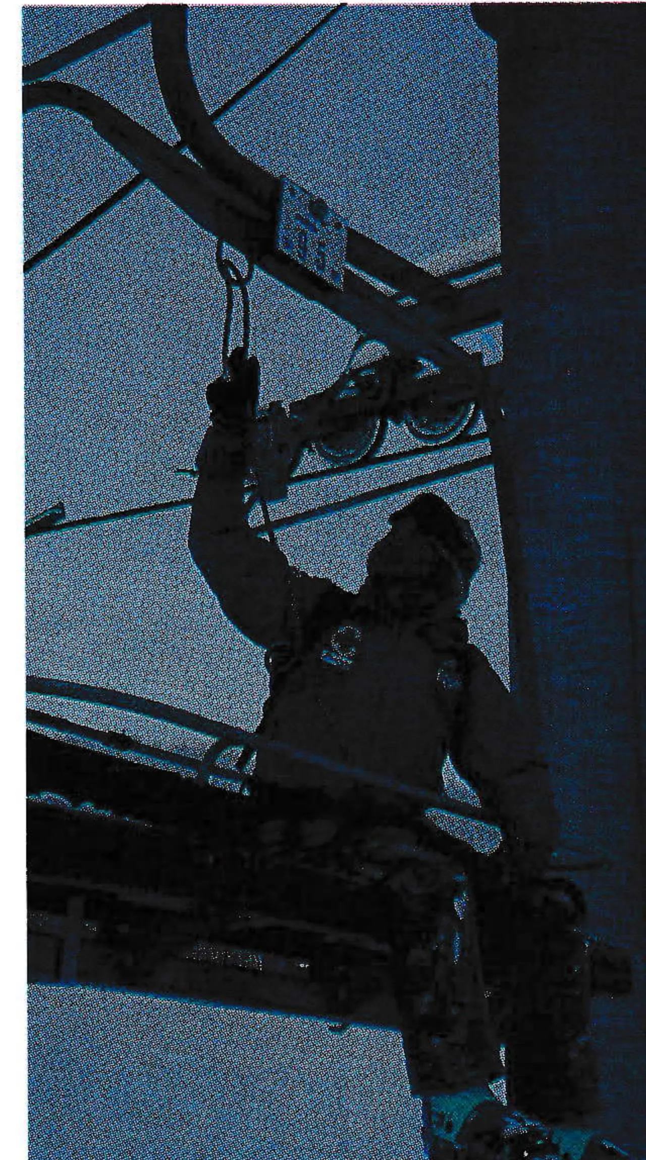 Passenger passes the main lowering rope through a ring on the chair.