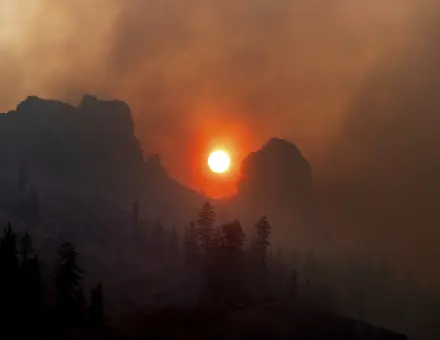 Smoke from the Caldor Fire wafts over a ridgetop near Kirkwood Ski Resort in Eldorado National Forest, Calif., on Tuesday, Aug. 31, 2021. (AP Photo/Noah Berger)