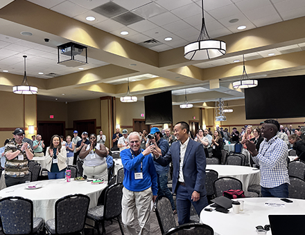 Friend of the Industry Award honoree Dave Kaufman from the University of Vermont in royal blue gets a standing ovation 1