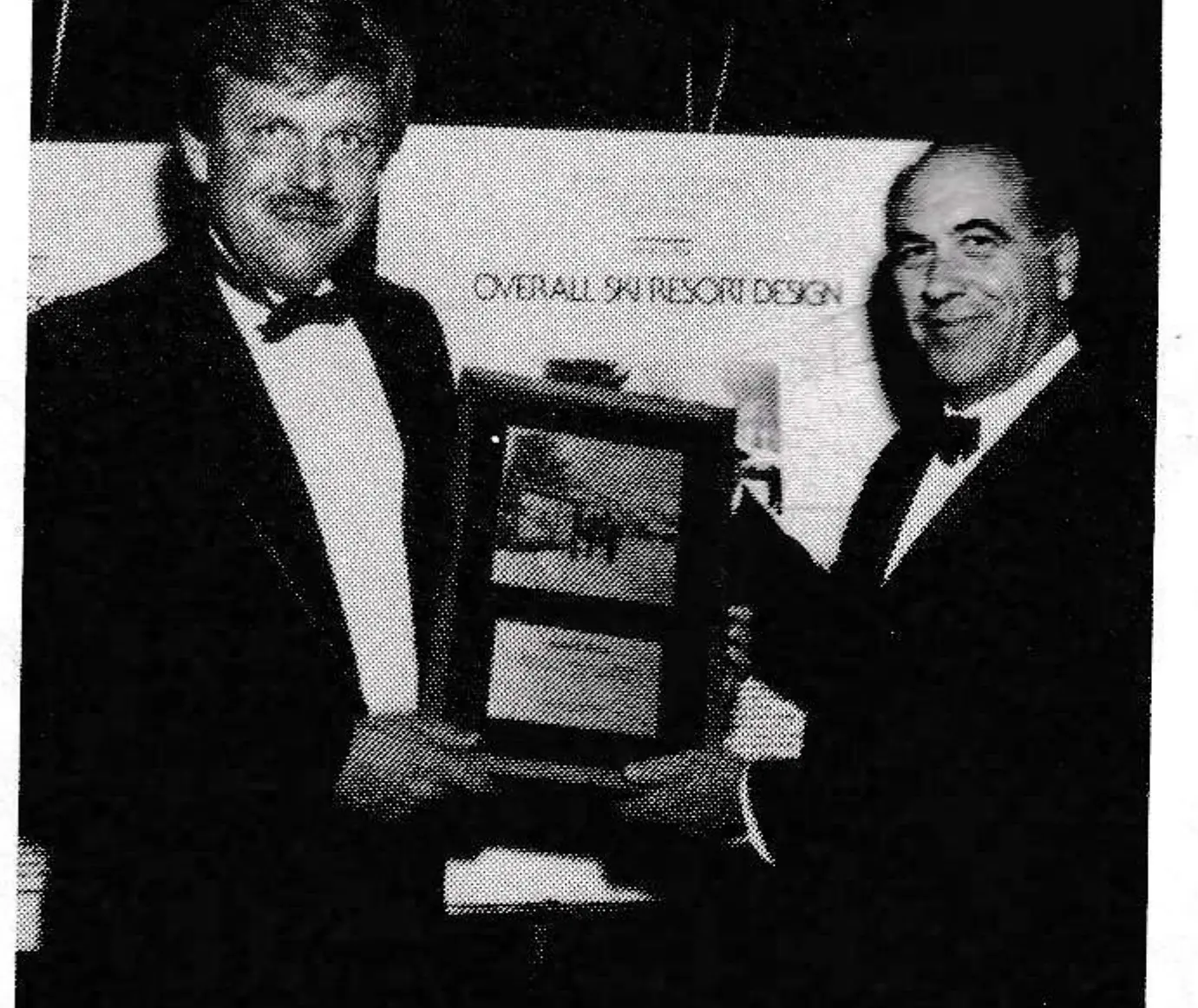 Brian Fairbank, left, receives a design award for Jiminy Peak from John Fry.