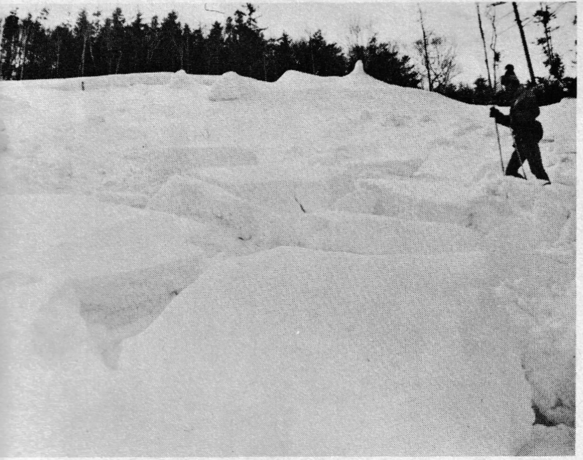 A Loon Mountain Ski Patroller checks out the first man-made avalanche in New England history. The slide occured on January 21st when overzealous snowmaking at the top of Big Dipper, an expert trail, proved to be more than gravity would allow. The refrigerator-sized chunks were strewn over a one acre area. Fortunately the trail was closed at the time. Loon Mountain is in Lincoln, New hampshire.