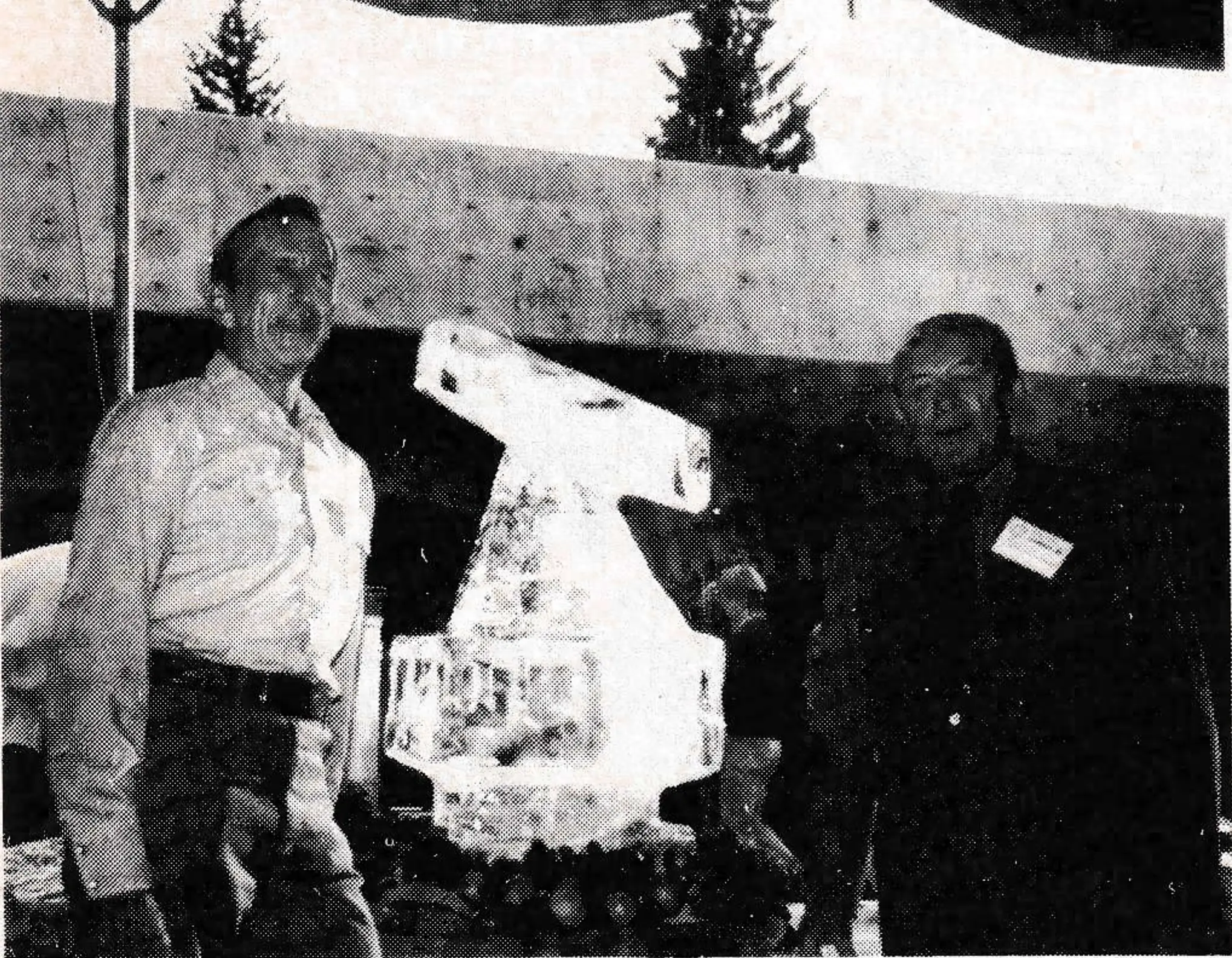 OITAF-NACS President Chuck Dwyer representative and symposium speaker, Max Clayton of London, England, with tramway ice sculpture.