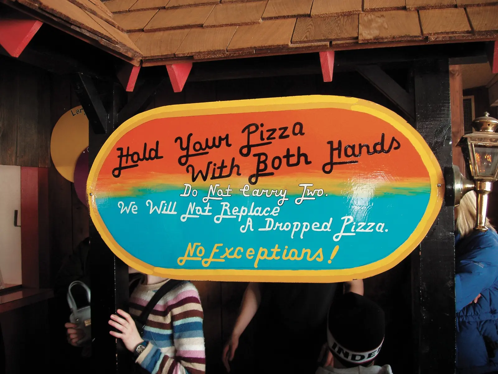 Sign at Wilmot Mountain reading “Hold Your Pizza With Both Hands”